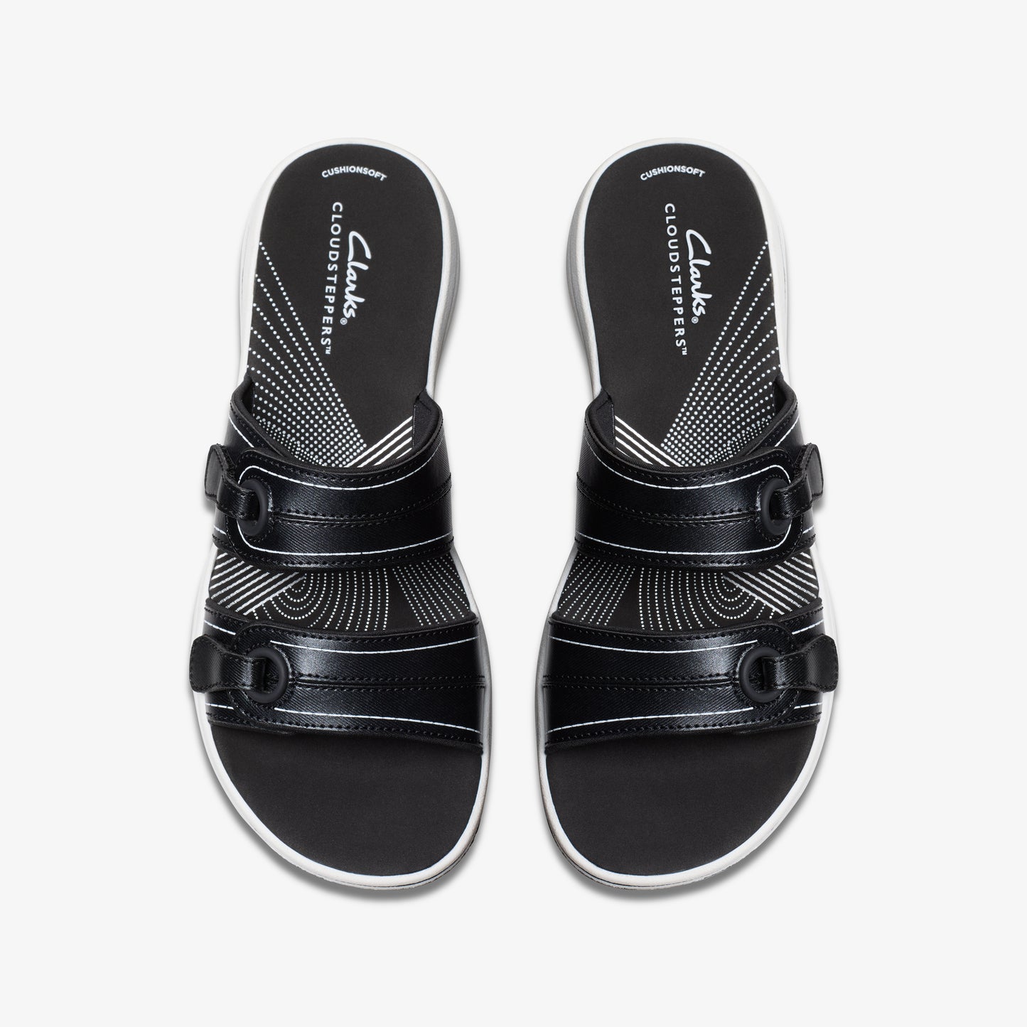 Overhead shot of pair of black sandals with two adjustable straps and white insole with "Cloudsteppers" print.