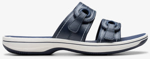 Navy slide sandal with adjustable hook-and-loop straps.