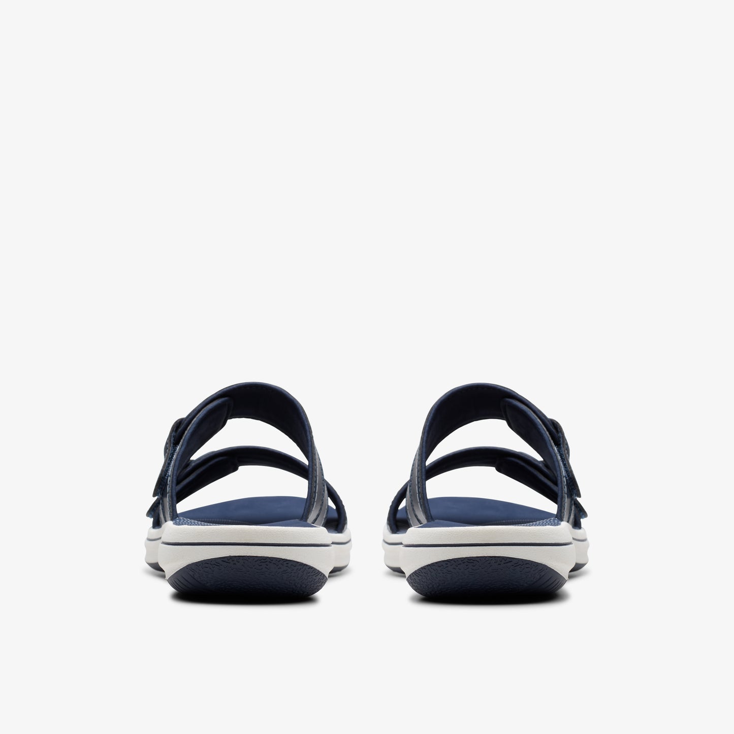 Two navy sandals with adjustable straps, seen from the back.
