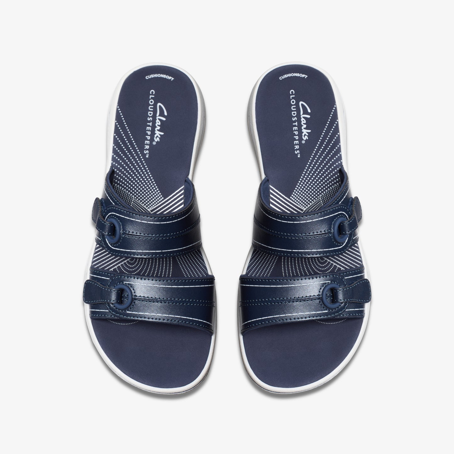 Pair of navy blue sandals with two adjustable straps and a white footbed with "CLOUDSTEPPERS" printed on it.