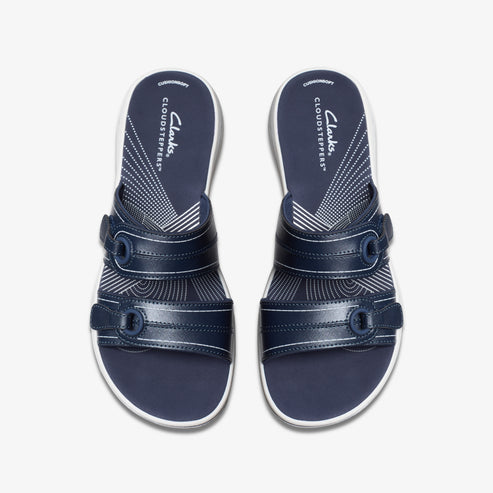 Pair of navy blue sandals with two adjustable straps and a white footbed with "CLOUDSTEPPERS" printed on it.
