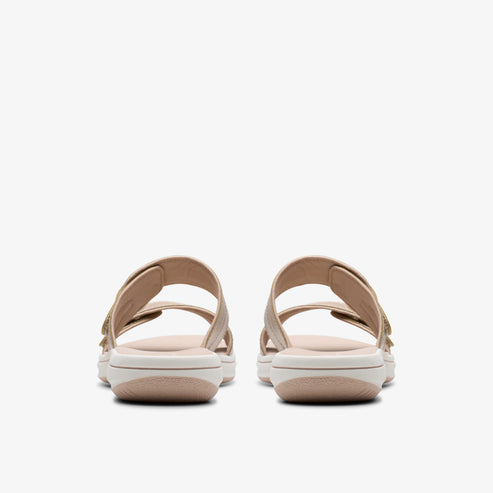 Rear view of two beige double-strap sandals with a white sole.