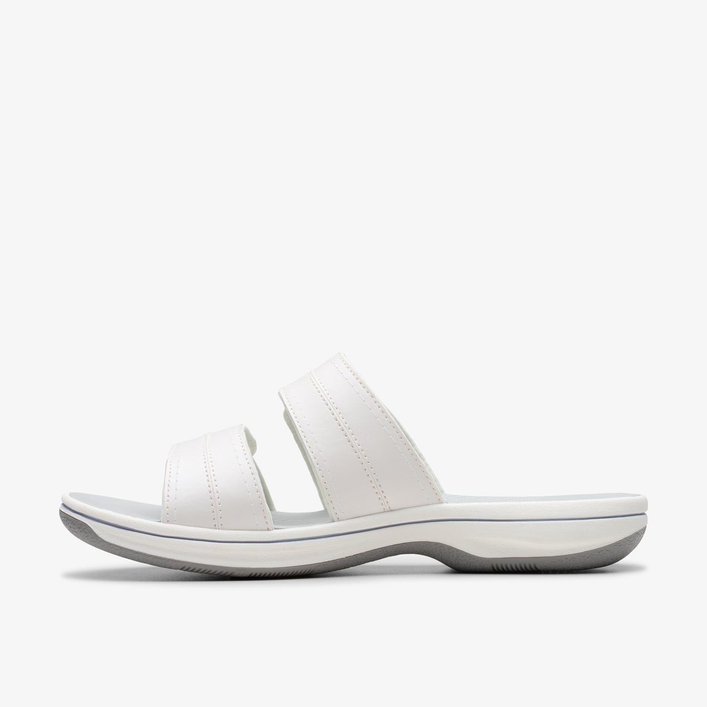 White sandal with two straps and a gray sole, seen from the side.