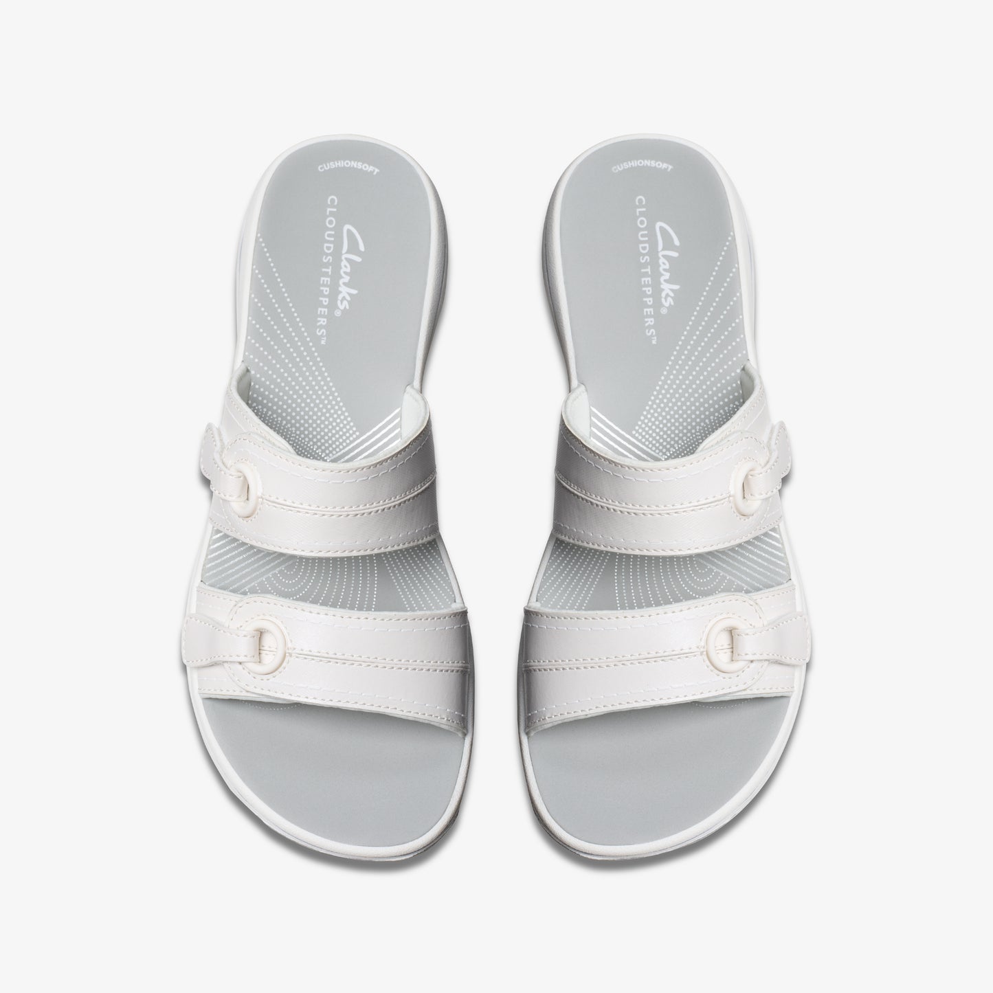 Overhead shot of a pair of Cloudsteppers white slide sandals with two buckled straps and a gray footbed.