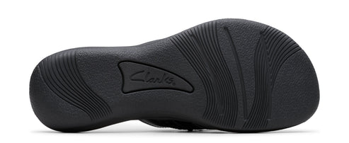 Sole of a dark-colored shoe with curved treads and the word "Clarks".