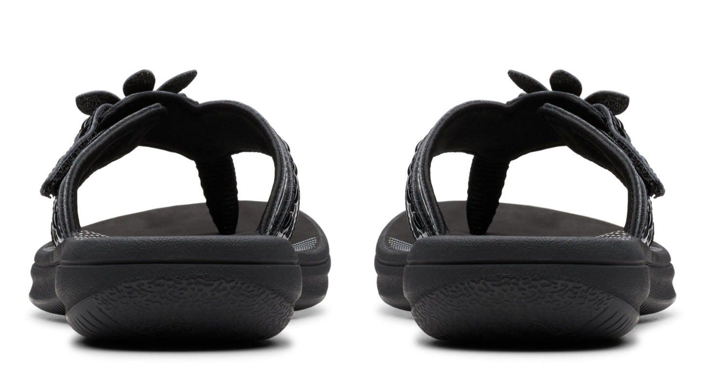 Pair of black flower-adorned thong sandals, back view.
