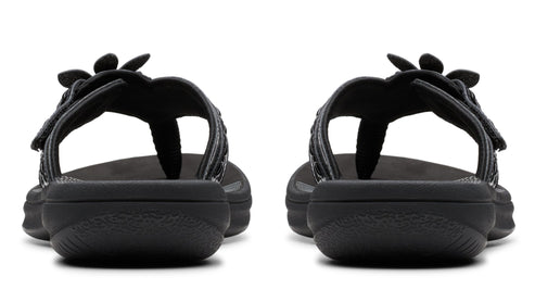 Pair of black flower-adorned thong sandals, back view.