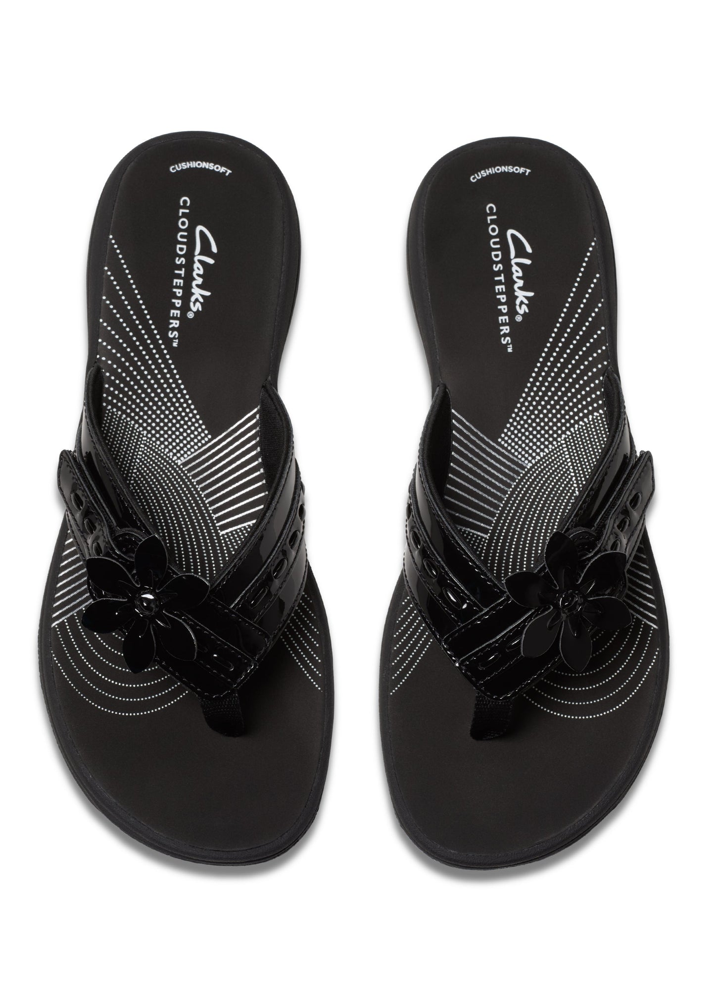 Pair of black CLOUDSTEPPERS flip flops with glossy straps and flower embellishments.