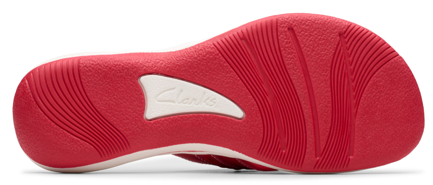 Red shoe sole with visible text "Clarks".