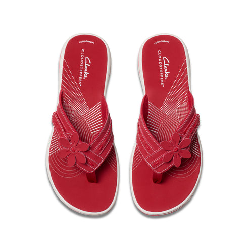 Pair of red CLOUDSTEPPERS flower flip-flops.