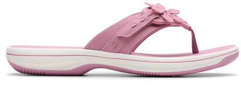 A pink sandal with a flower.