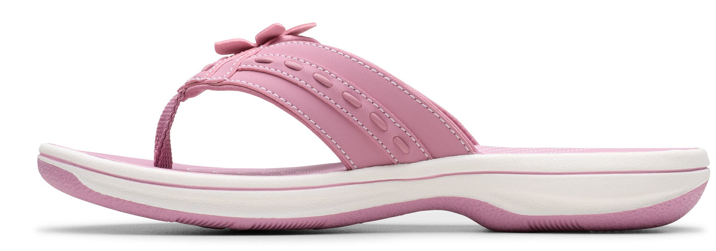 A pink sandal with a white sole.