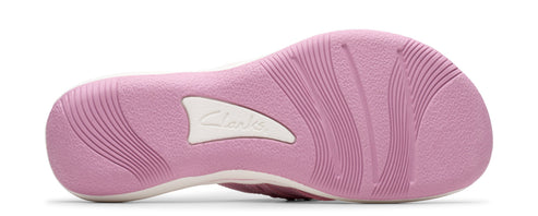 Pink shoe sole with white logo and grooves.