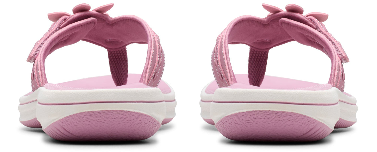 A pair of pink toddler girl sandals with a white stripe.