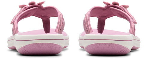 A pair of pink toddler girl sandals with a white stripe.