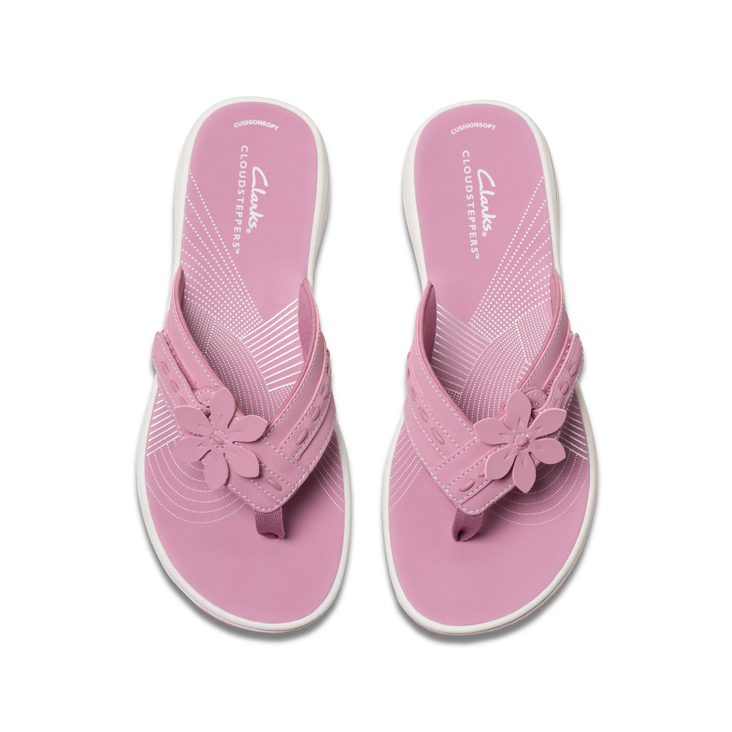 Pink flower-embellished flip-flops with white soles, top view.