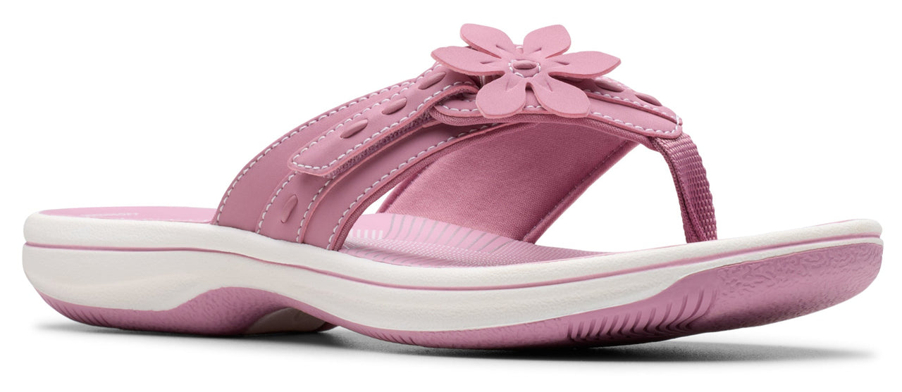 Pink sandal with flower embellishment.