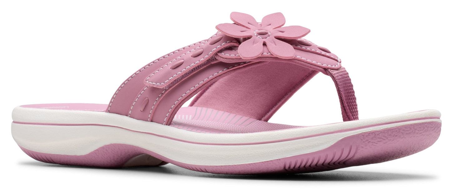 Pink sandal with flower embellishment.