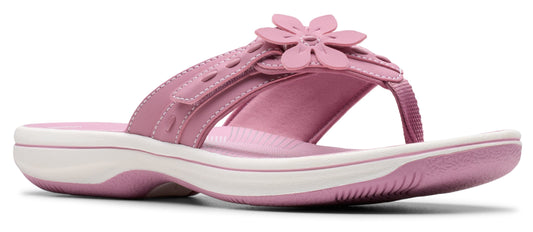 Pink sandal with flower embellishment.