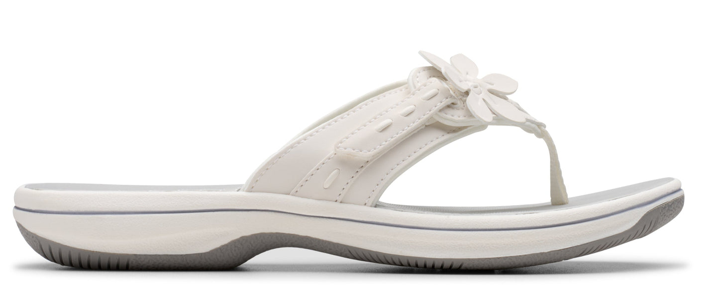 White sandal with flower detail.