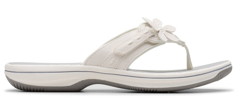 White sandal with flower detail.