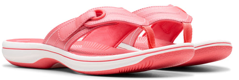 A pair of pink thong sandals with a white sole.