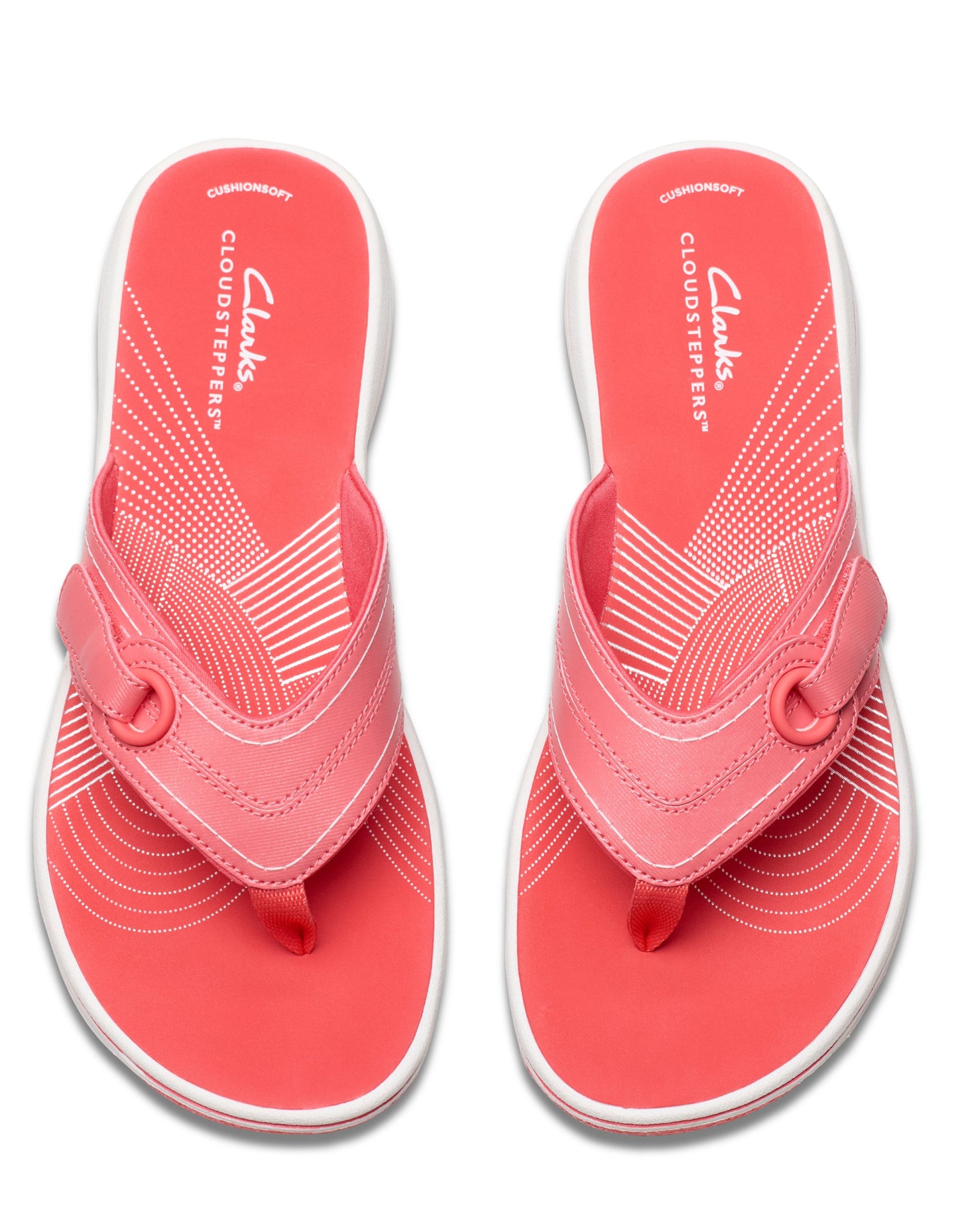 A pair of coral-colored flip flops with a white sole and circular patterns near the toe.