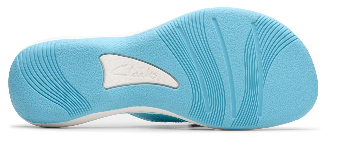 A light-blue shoe sole with linear design, featuring a white brand logo in the middle.