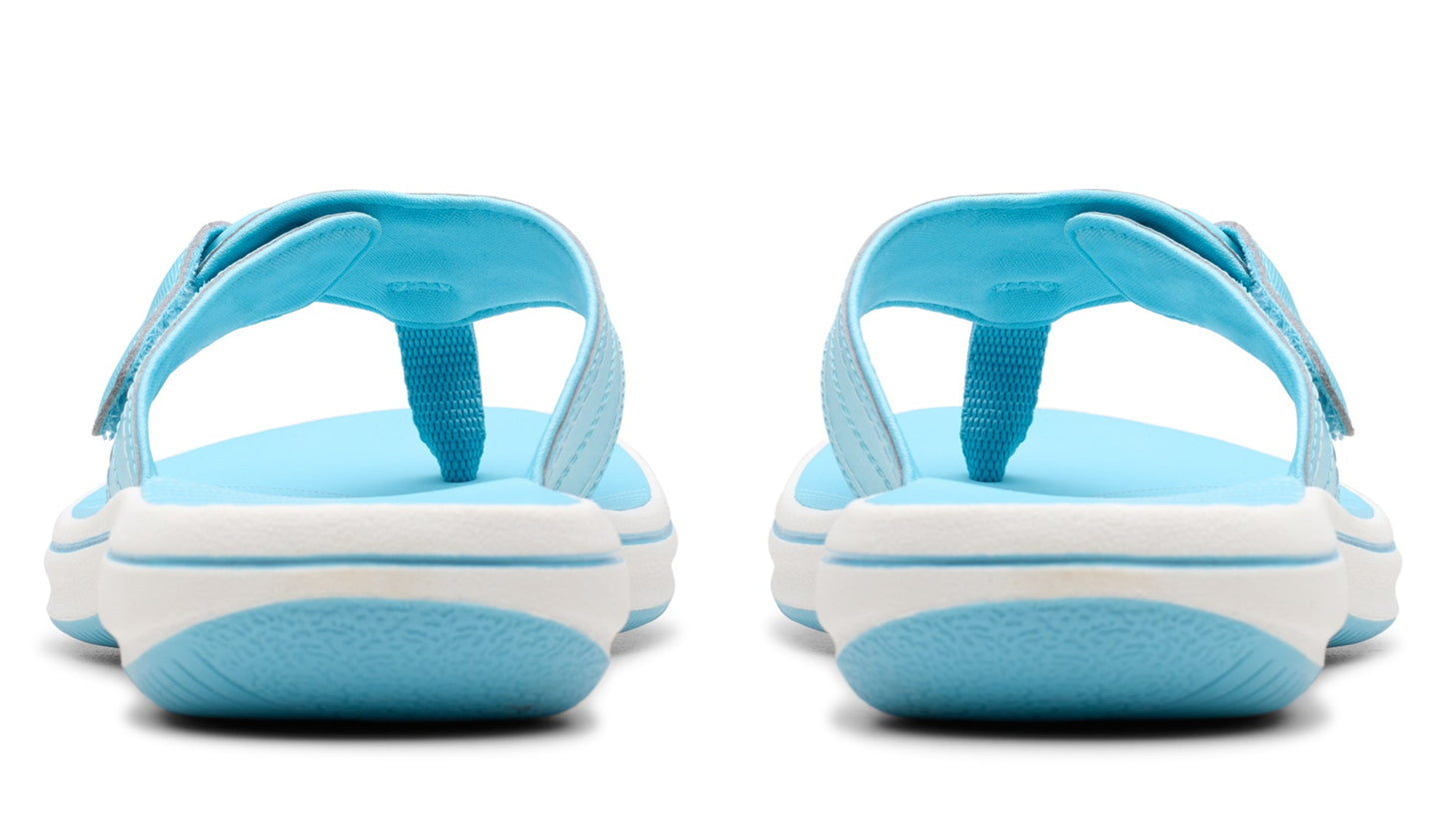 Rear view of two sky blue and white sandals with toe posts and Velcro straps.
