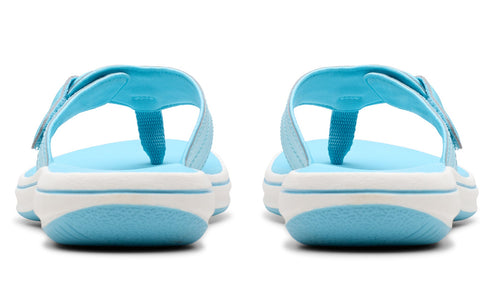 Rear view of two sky blue and white sandals with toe posts and Velcro straps.