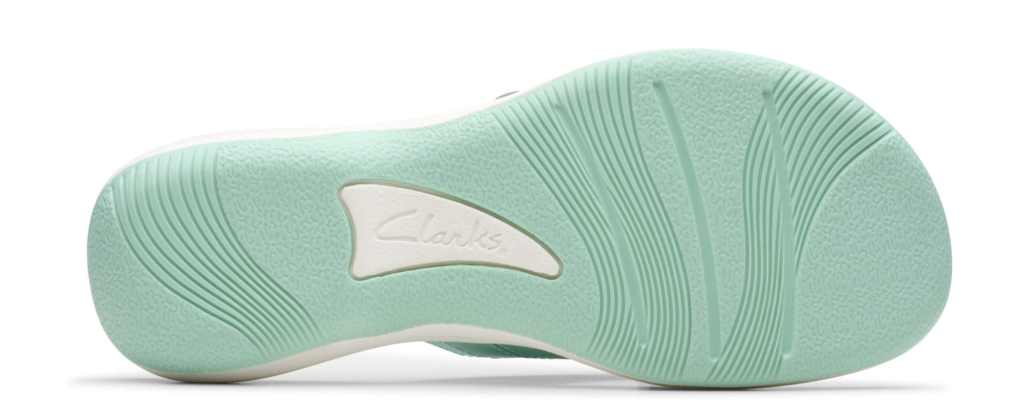 Light green shoe sole with wavy patterns and a white logo in the center.