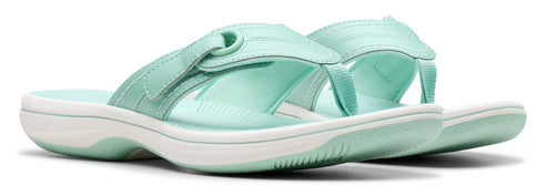 A pair of light green sandals with white soles.