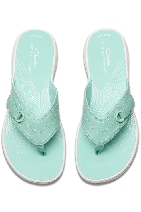 Overhead view of two seafoam green flip-flops with toe posts and white soles.