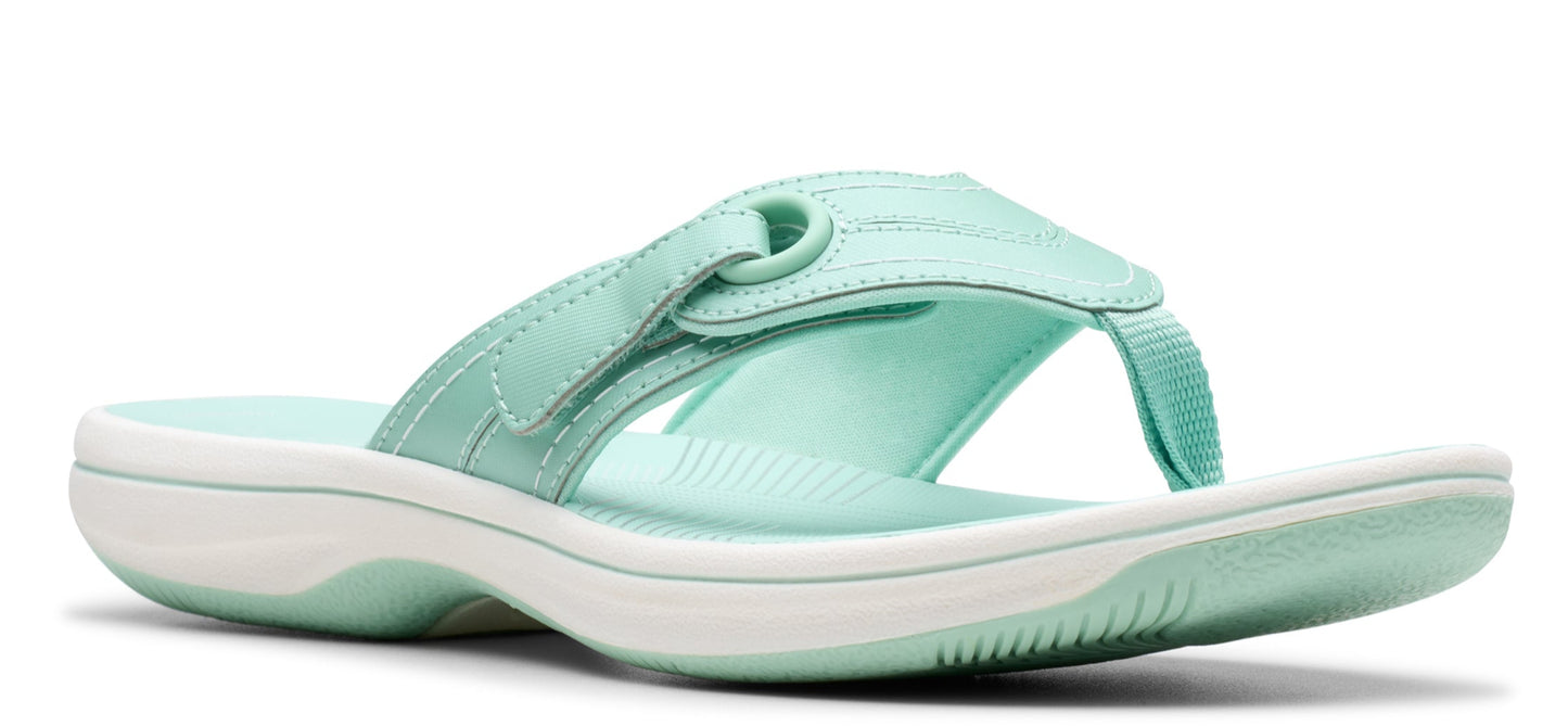 A mint green flip-flop with a white sole.