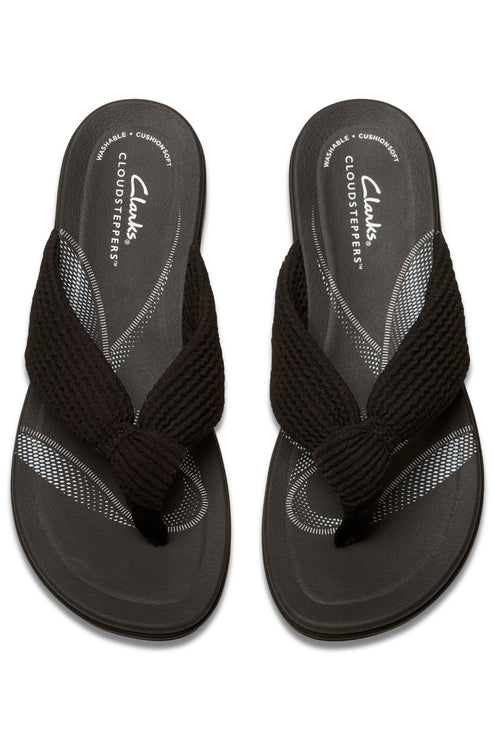 Pair of black flip flops with black braided straps and "CLARKS CLOUDSTEPPERS" logo printed on the insole.