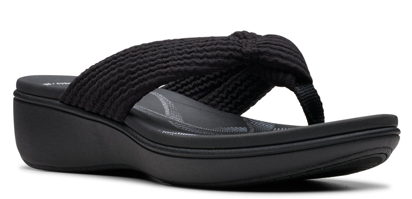 A black sandal with a wedge heel and a knitted upper.