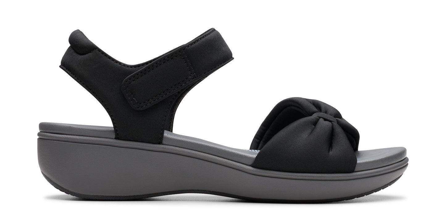 A black sandal with a hook and loop fastener.