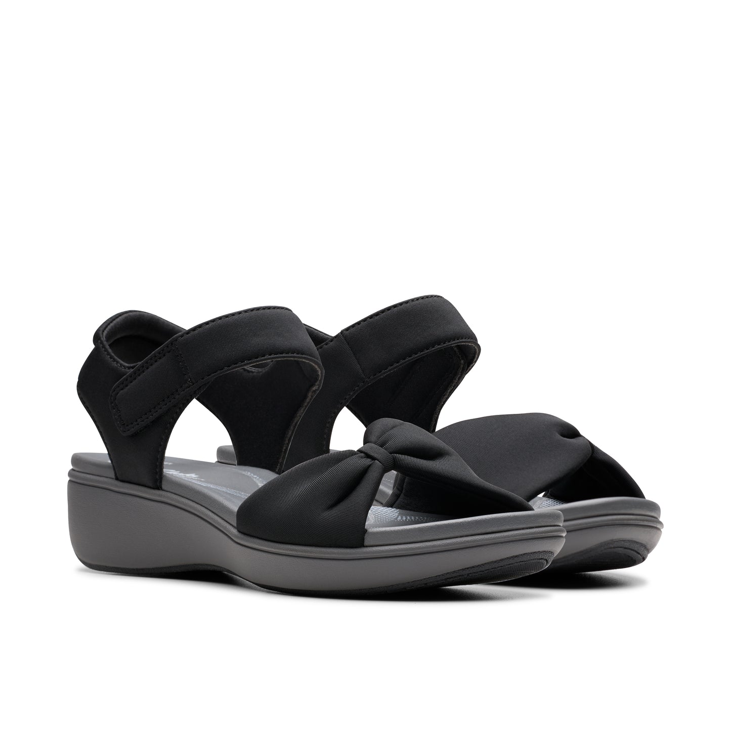 A pair of black sandals with an adjustable velcro ankle strap and knot detail over the toes.
