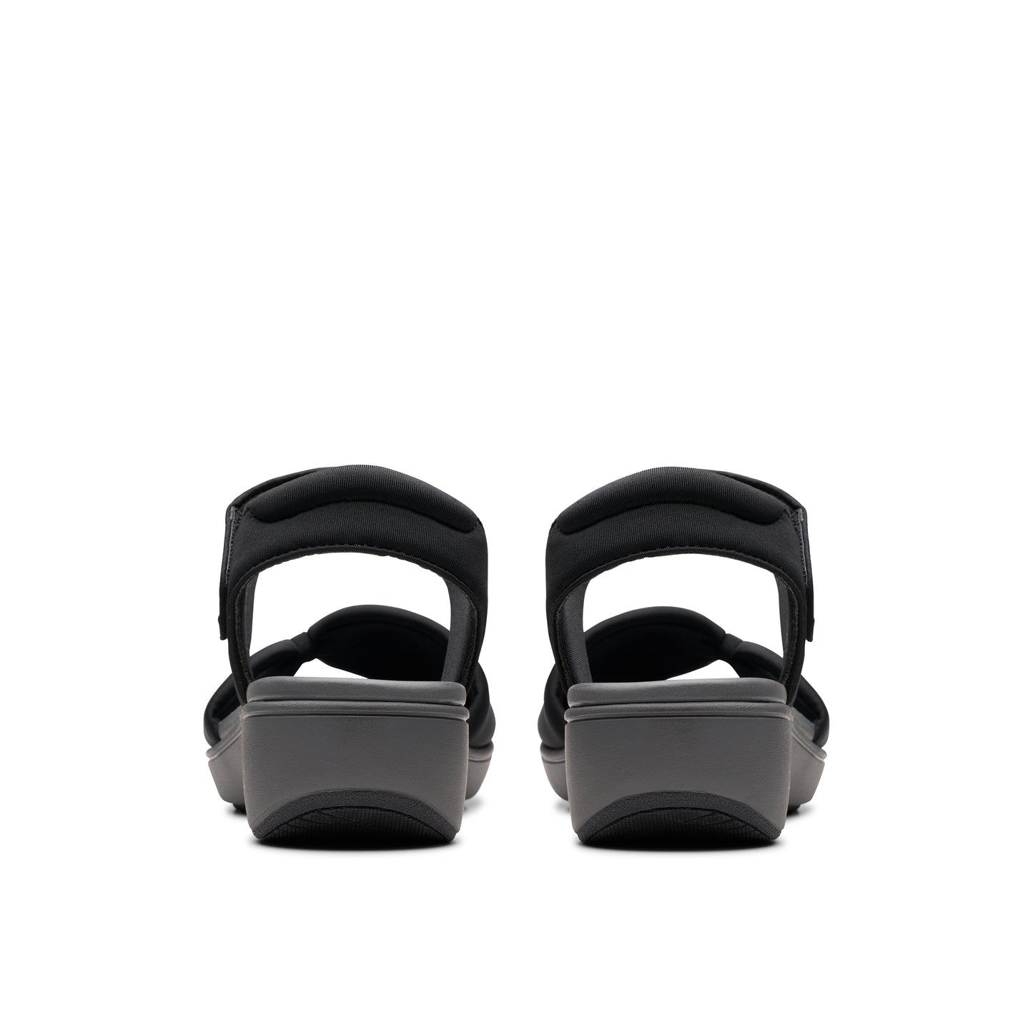 Two identical black wedge sandals facing away, adjustable hook and loop straps.