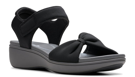 Black wedge sandal with hook-and-loop ankle strap and knotted toe strap.