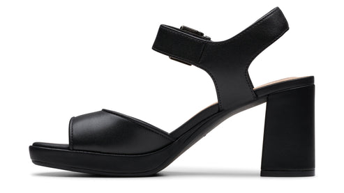 Black block heel sandal with open toe and adjustable ankle strap.