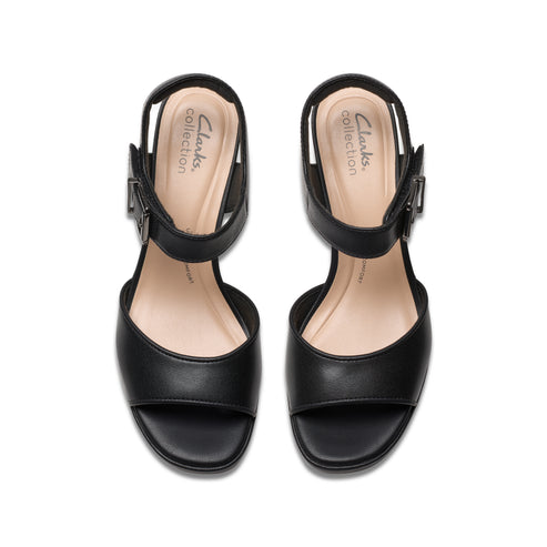 Two black, open-toe sandals with adjustable buckled straps and beige soles, viewed from above.