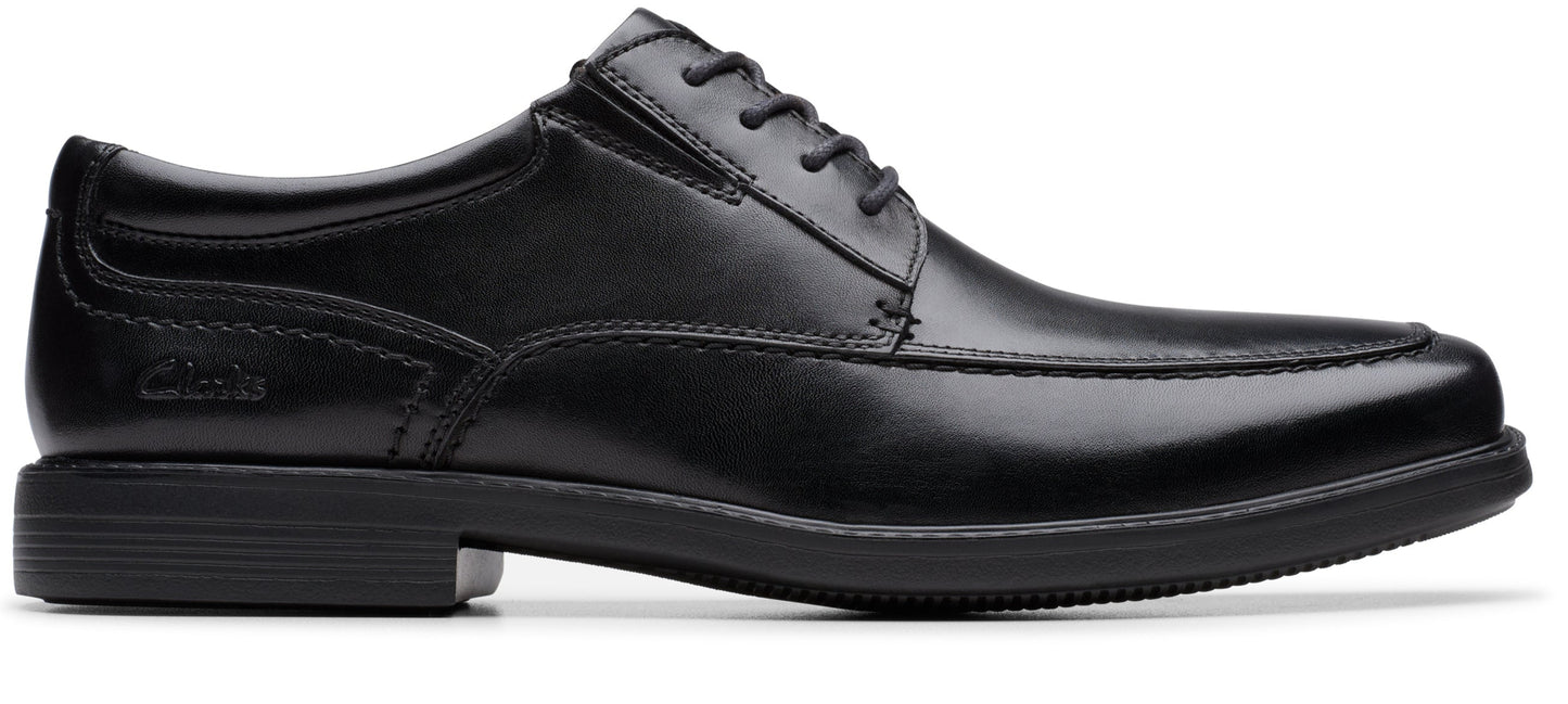 A black leather dress shoe with a lace-up closure.