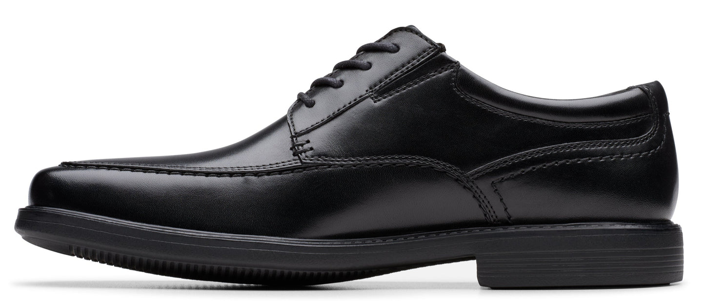 A black leather dress shoe with a lace-up closure and a rounded toe.