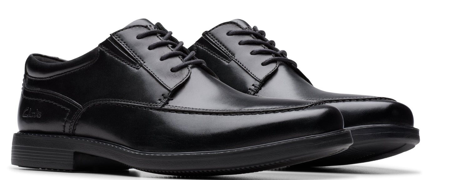A pair of shiny black leather dress shoes with black laces.