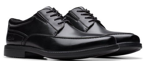 A pair of shiny black leather dress shoes with black laces.