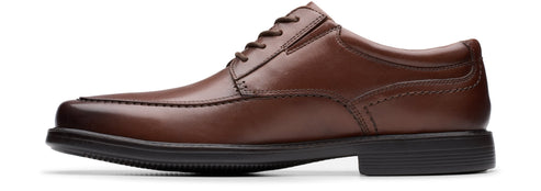 A brown leather dress shoe with a black sole.