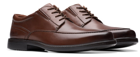 A pair of brown leather dress shoes with laces.