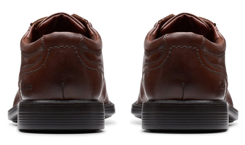 Pair of brown leather dress shoes, rear view.