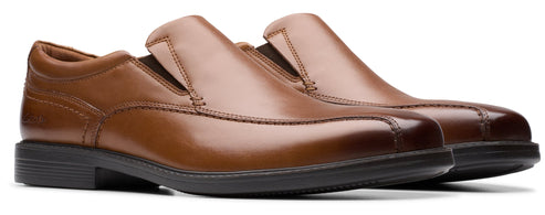 A pair of brown leather slip-on dress shoes with black soles.